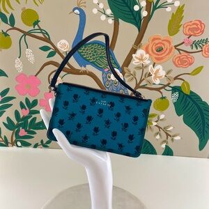 Coach Turquoise Zipper Wallet with Black Rose Pattern.